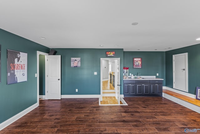 interior space with sink and dark wood-type flooring