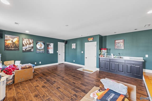 living room with dark hardwood / wood-style flooring and indoor wet bar