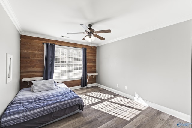 bedroom with crown molding, wood-type flooring, and wood walls