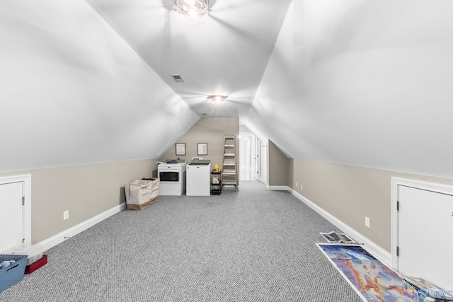 additional living space featuring lofted ceiling, carpet flooring, and washing machine and dryer