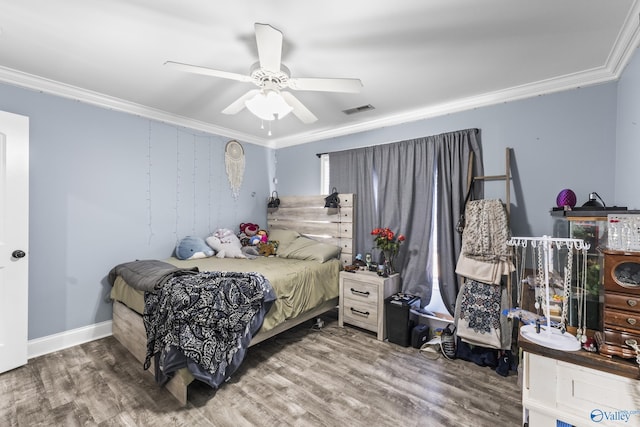 bedroom with crown molding, ceiling fan, and hardwood / wood-style flooring