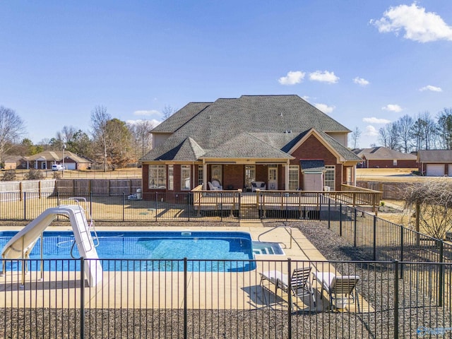 view of pool featuring a patio and a water slide