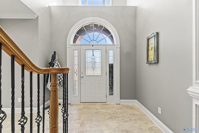 entrance foyer featuring a towering ceiling