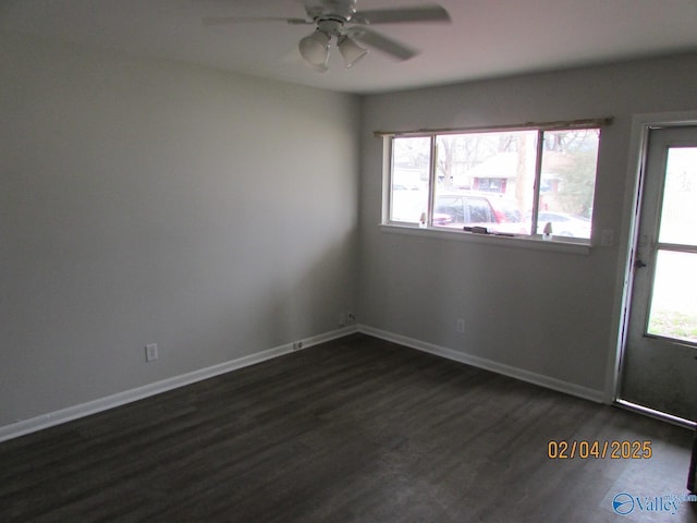 unfurnished room featuring ceiling fan, a wealth of natural light, and dark hardwood / wood-style flooring