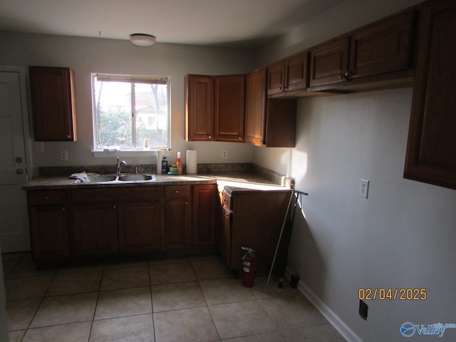 kitchen featuring sink and light tile patterned floors