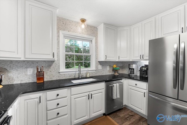 1762 Old Big Cove Rd SE, Owens Cross Roads, AL 35763 - kitchen with white cabinets, a sink, dark wood-style flooring, appliances with stainless steel finishes, and backsplash
