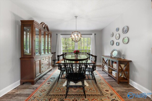 1762 Old Big Cove Rd SE, Owens Cross Roads, AL 35763 - dining room featuring a chandelier, baseboards, a textured ceiling, and wood finished floors
