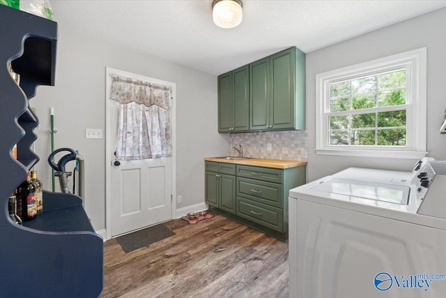 1762 Old Big Cove Rd SE, Owens Cross Roads, AL 35763 - clothes washing area with a sink, a textured ceiling, dark wood-style floors, cabinet space, and washer and clothes dryer