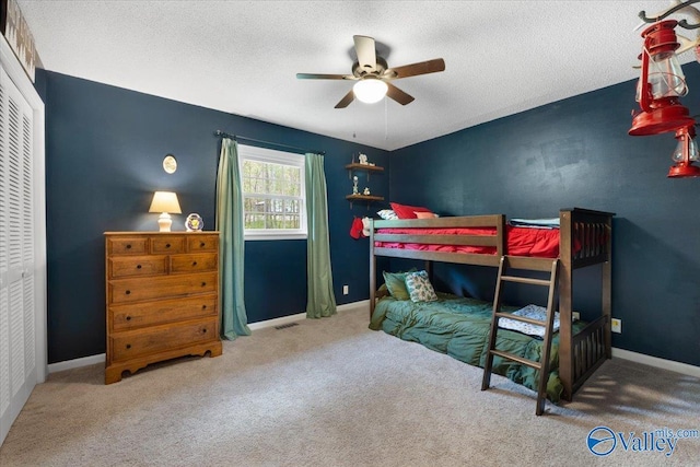 1762 Old Big Cove Rd SE, Owens Cross Roads, AL 35763 - carpeted bedroom featuring baseboards, a closet, and a textured ceiling