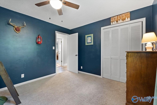1762 Old Big Cove Rd SE, Owens Cross Roads, AL 35763 - unfurnished bedroom with ceiling fan, a closet, carpet flooring, and baseboards