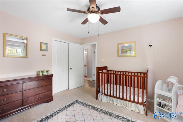 1762 Old Big Cove Rd SE, Owens Cross Roads, AL 35763 - bedroom featuring a crib, a closet, a ceiling fan, and carpet