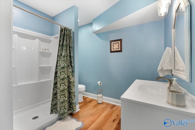 1762 Old Big Cove Rd SE, Owens Cross Roads, AL 35763 - bathroom with vanity, baseboards, a stall shower, toilet, and wood finished floors