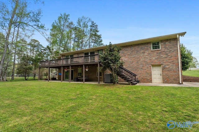 1762 Old Big Cove Rd SE, Owens Cross Roads, AL 35763 - back of property featuring cooling unit, stairs, brick siding, a wooden deck, and a yard