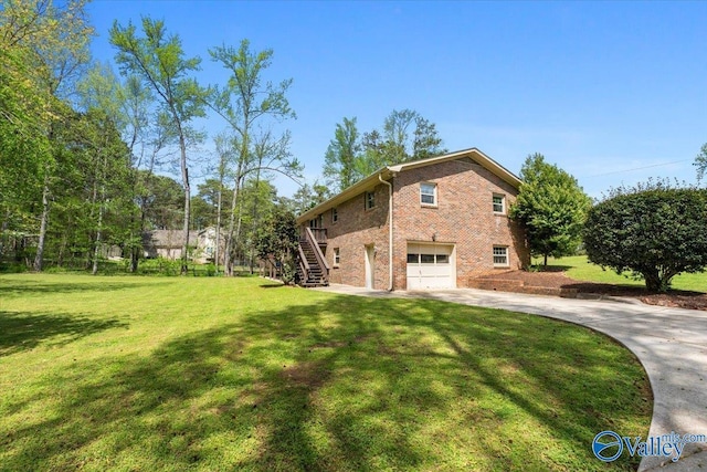 1762 Old Big Cove Rd SE, Owens Cross Roads, AL 35763 - view of home's exterior featuring concrete driveway, stairs, brick siding, a garage, and a yard