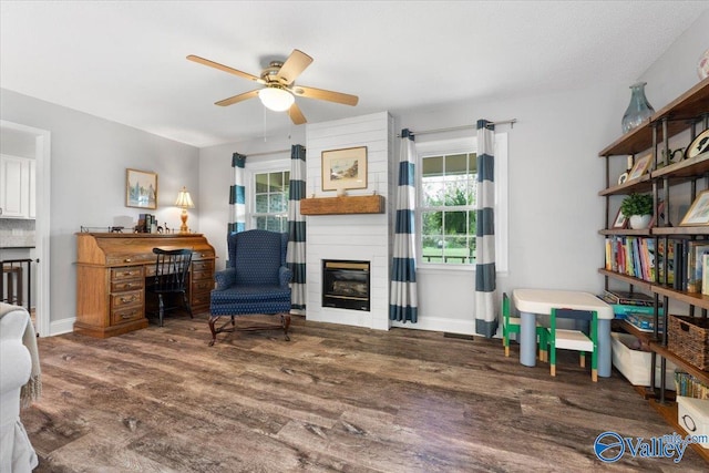 1762 Old Big Cove Rd SE, Owens Cross Roads, AL 35763 - living area featuring baseboards, a large fireplace, a ceiling fan, and wood finished floors
