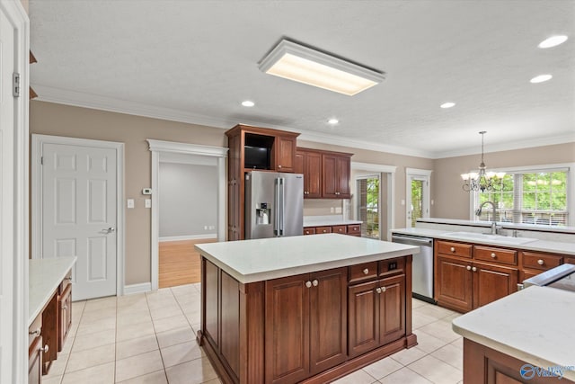 kitchen featuring a sink, light countertops, a kitchen island, and stainless steel appliances