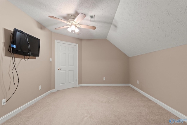 bonus room with carpet flooring, a ceiling fan, a textured ceiling, and lofted ceiling
