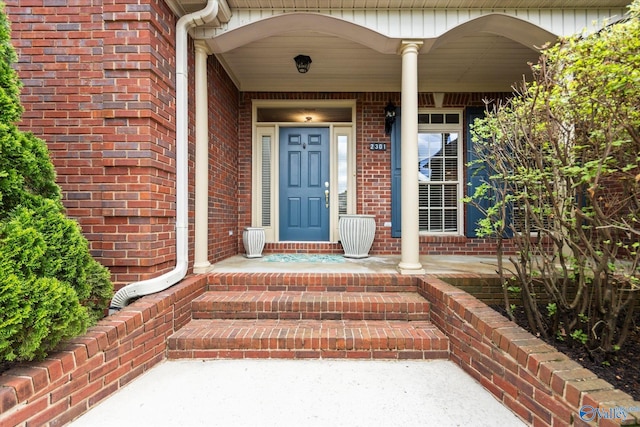 property entrance featuring brick siding
