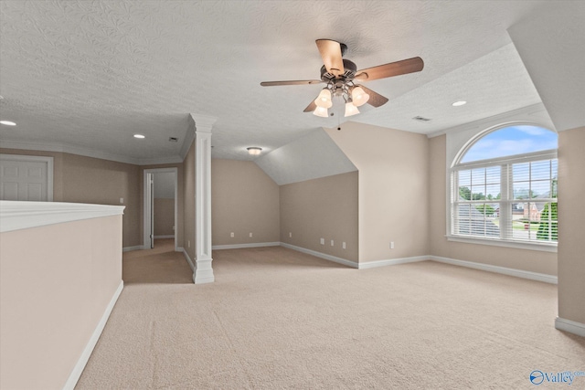 additional living space featuring carpet floors, a textured ceiling, and baseboards