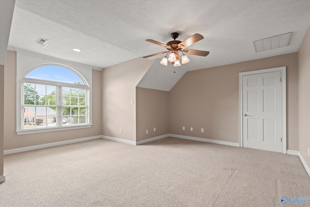 bonus room featuring light carpet, a ceiling fan, and visible vents