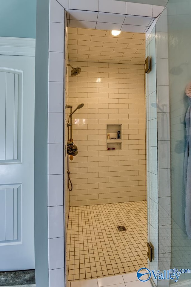 bathroom with a tile shower