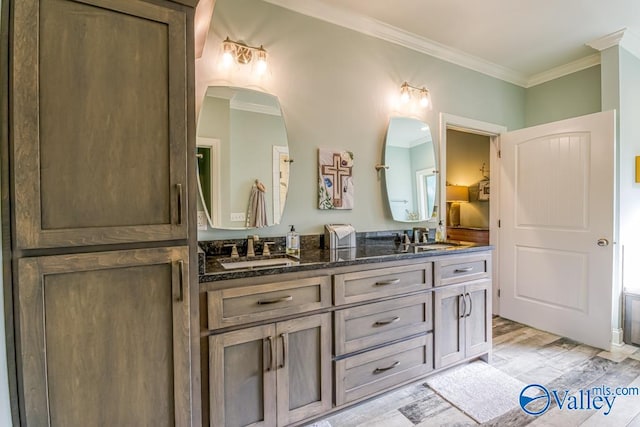 bathroom with ornamental molding and vanity