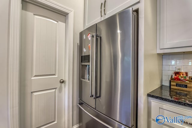 kitchen with white cabinets, dark stone countertops, backsplash, and high end refrigerator