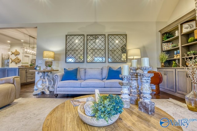 living room featuring vaulted ceiling and hardwood / wood-style flooring