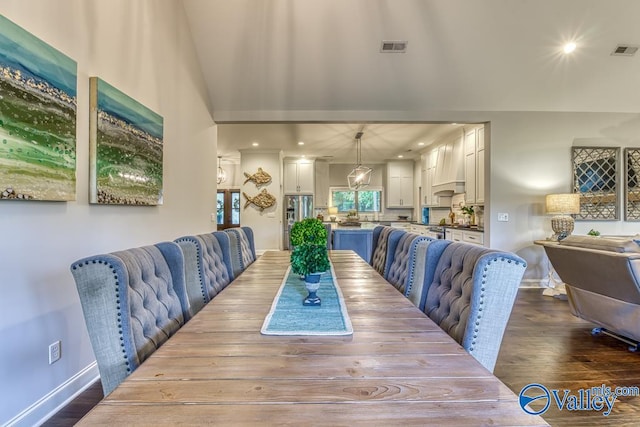 dining space featuring dark wood-type flooring