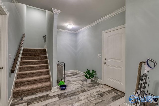 foyer entrance featuring crown molding and wood-type flooring