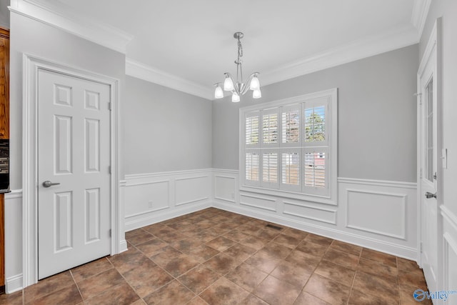 unfurnished dining area featuring ornamental molding and a chandelier