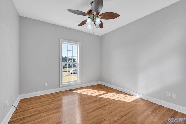 spare room with light wood-type flooring and ceiling fan