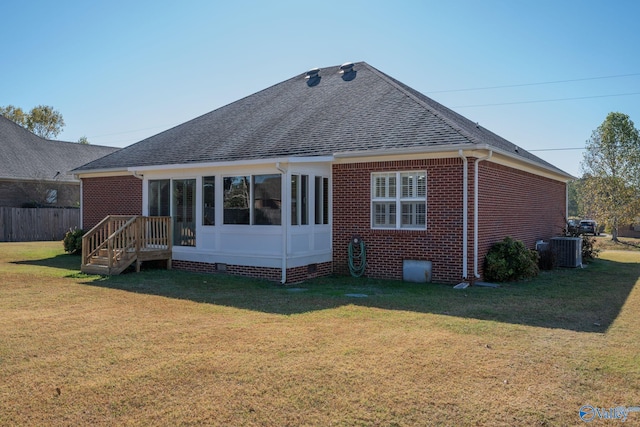 back of house featuring cooling unit and a yard