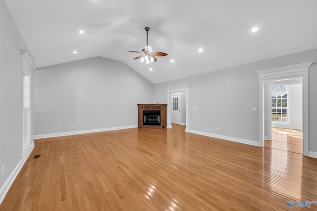 unfurnished living room featuring ceiling fan, lofted ceiling, and light wood-type flooring