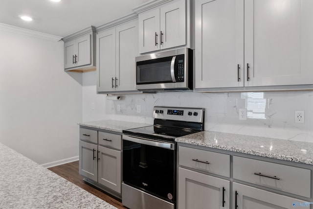 138 Barlow Way, Owens Cross Roads, AL 35763 - kitchen featuring dark wood-style floors, stainless steel appliances, backsplash, gray cabinetry, and ornamental molding