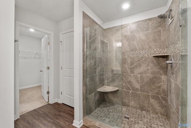 138 Barlow Way, Owens Cross Roads, AL 35763 - full bathroom with a spacious closet, baseboards, a tile shower, and wood finished floors