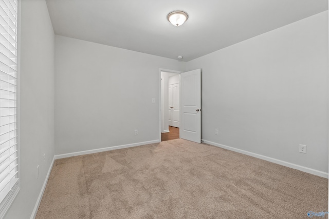 138 Barlow Way, Owens Cross Roads, AL 35763 - unfurnished bedroom featuring carpet, multiple windows, and baseboards