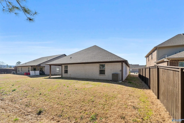 138 Barlow Way, Owens Cross Roads, AL 35763 - back of house featuring brick siding, a lawn, fence, and central AC unit