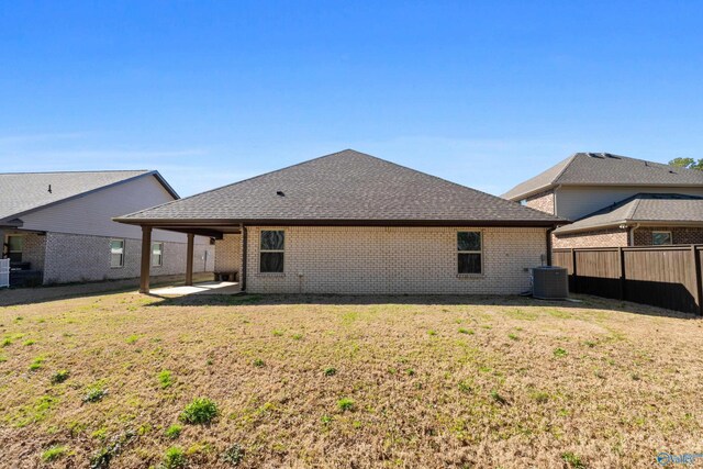 138 Barlow Way, Owens Cross Roads, AL 35763 - rear view of property with central AC unit, a lawn, fence, a patio area, and brick siding