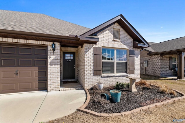 138 Barlow Way, Owens Cross Roads, AL 35763 - view of front of home with a garage, brick siding, and roof with shingles