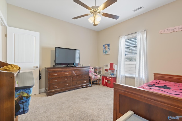 bedroom with ceiling fan and light carpet