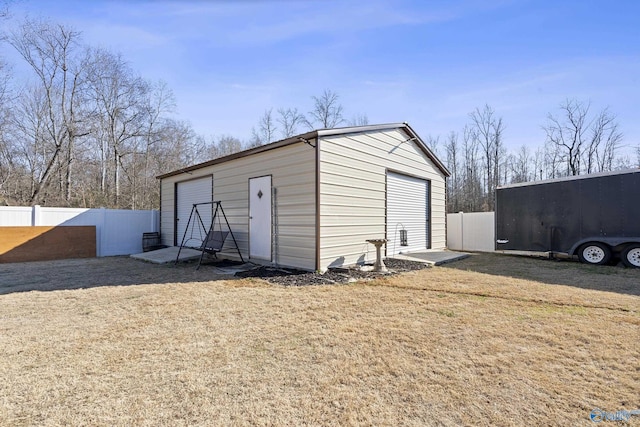 view of outdoor structure featuring a yard and a garage