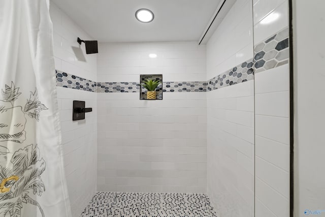 bathroom with tiled shower