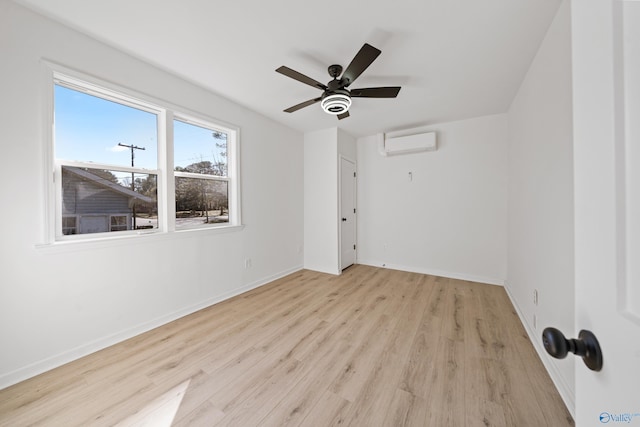 unfurnished room with ceiling fan, baseboards, wood finished floors, and a wall mounted air conditioner