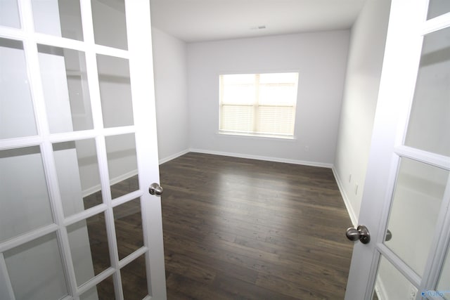 spare room with dark hardwood / wood-style flooring