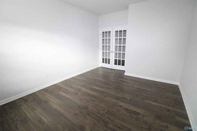 unfurnished room featuring french doors and dark wood-type flooring