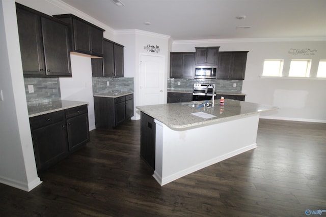 kitchen featuring backsplash, sink, a center island with sink, and appliances with stainless steel finishes