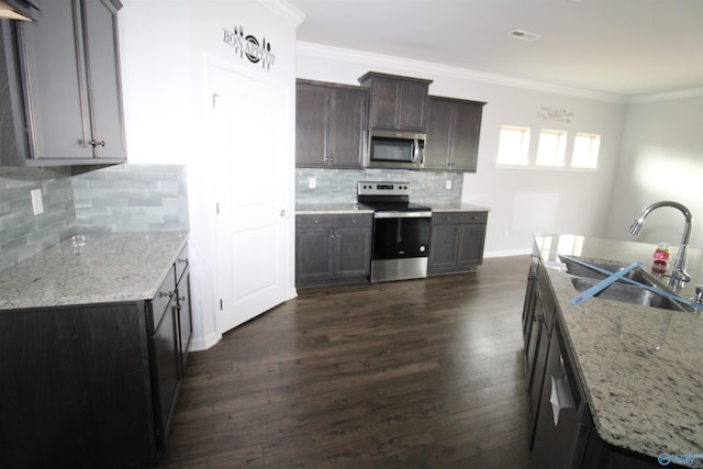 kitchen with crown molding, sink, tasteful backsplash, light stone counters, and stainless steel appliances