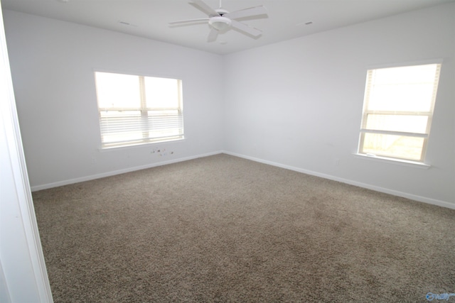 carpeted spare room featuring ceiling fan