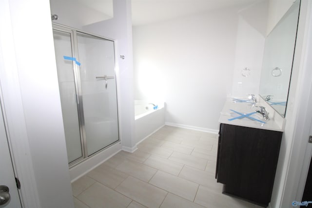 bathroom featuring tile patterned flooring, vanity, and shower with separate bathtub